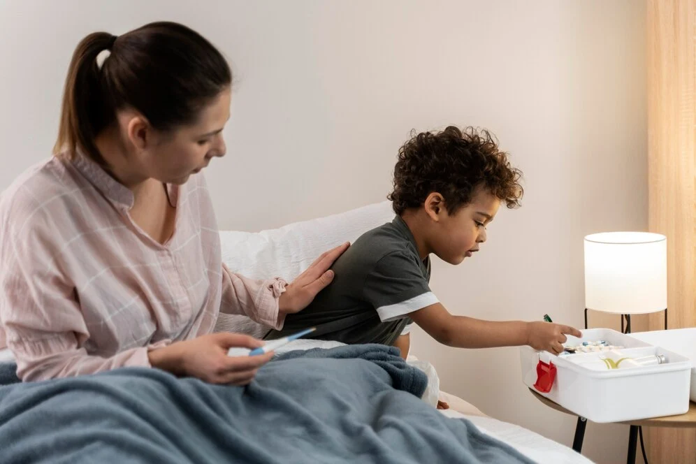 Boy is taking medicine with mother